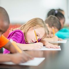 Kids writing a test and taking a quiz