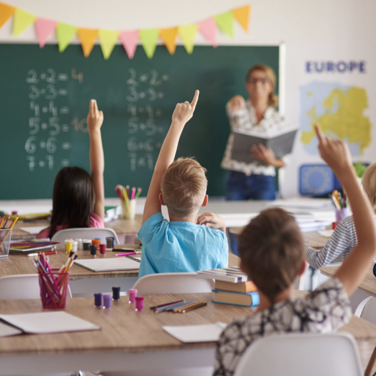children raising hands