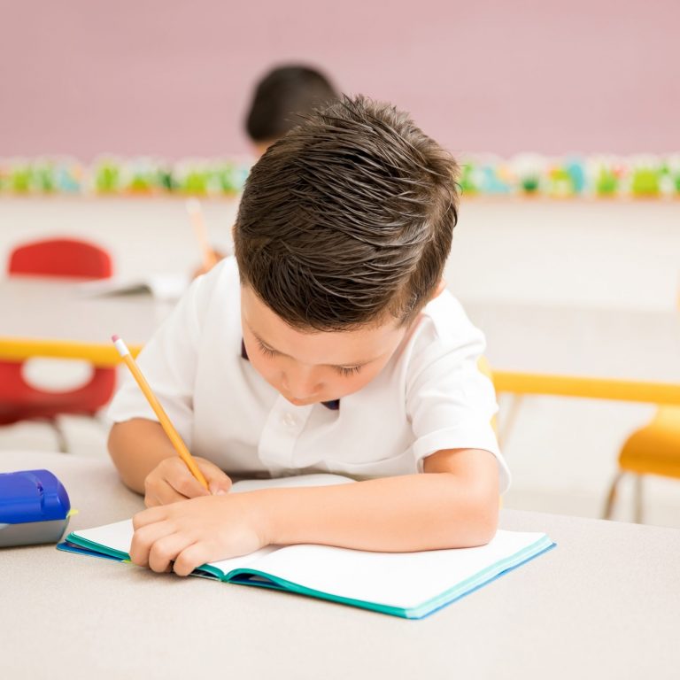 kid writing on paper